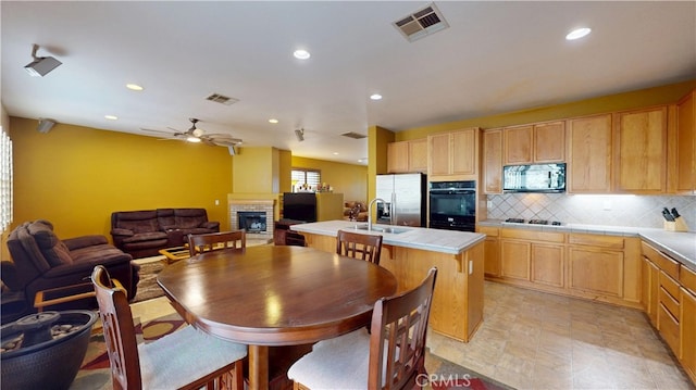 dining space with a ceiling fan, recessed lighting, visible vents, and a fireplace