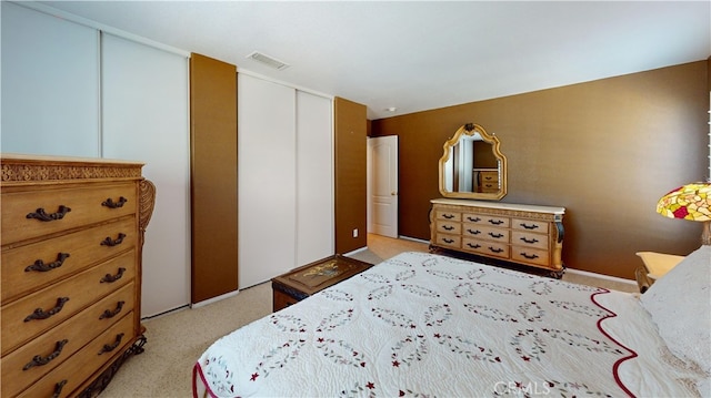 bedroom with light carpet and visible vents