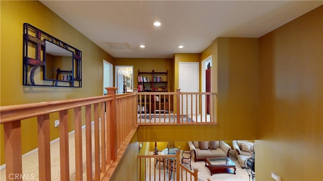 corridor with wainscoting, an upstairs landing, and recessed lighting