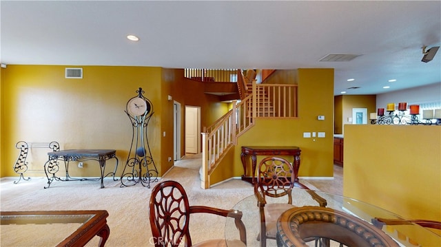 interior space with light colored carpet, recessed lighting, visible vents, and stairway