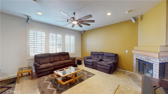 living area featuring a ceiling fan, recessed lighting, a brick fireplace, and baseboards