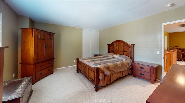 bedroom featuring visible vents and light colored carpet