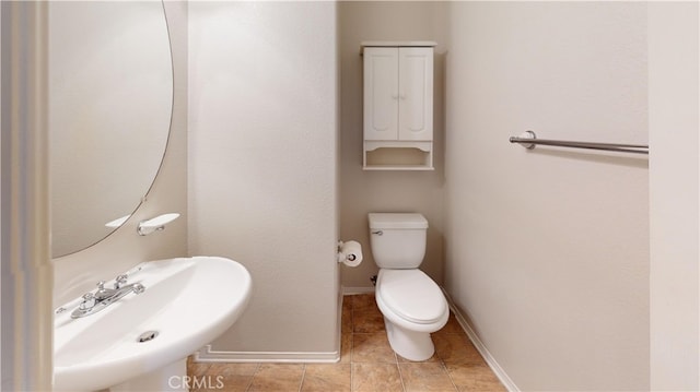 11318 Fitzpatrick Dr, Rancho Cucamonga, CA 91730 - bathroom featuring toilet, a sink, baseboards, and tile patterned flooring