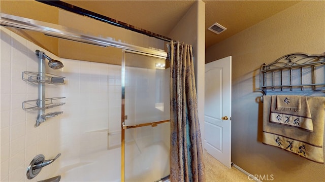 bathroom featuring visible vents and shower / bath combination with glass door