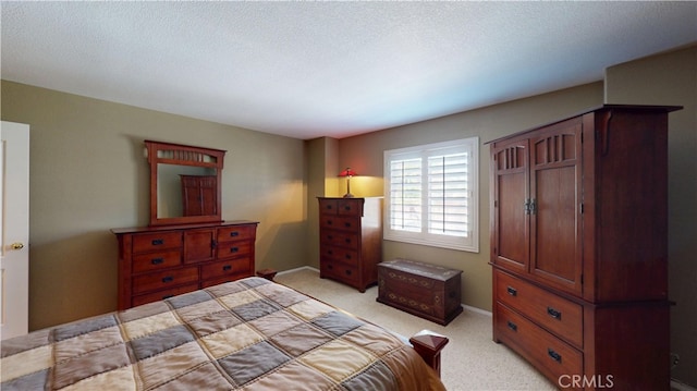 bedroom featuring a textured ceiling, baseboards, and light colored carpet