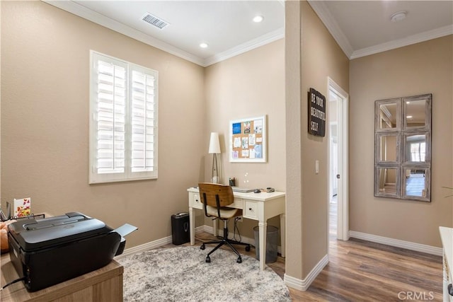 office area featuring ornamental molding, wood finished floors, visible vents, and baseboards