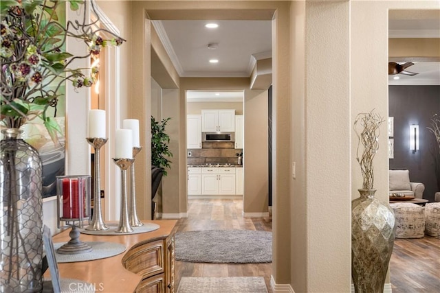 corridor with recessed lighting, baseboards, crown molding, and wood finished floors