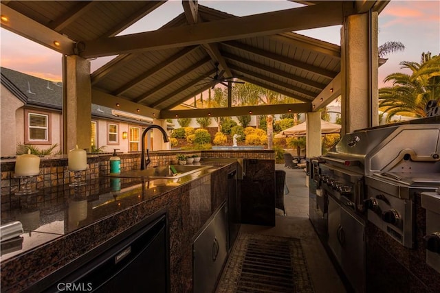 view of patio / terrace featuring ceiling fan, a gazebo, an outdoor kitchen, and a sink