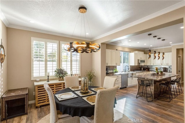 dining space with dark wood-style floors, ornamental molding, a textured ceiling, and baseboards