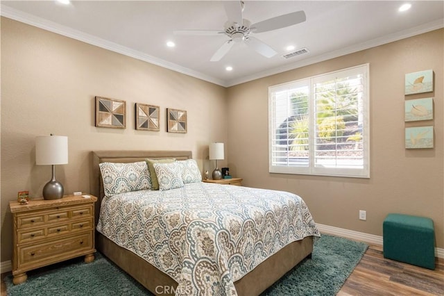 bedroom featuring recessed lighting, wood finished floors, visible vents, baseboards, and crown molding