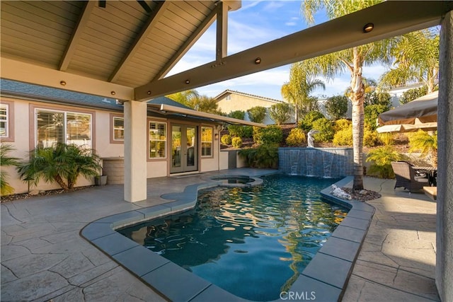 outdoor pool with a hot tub, french doors, and a patio