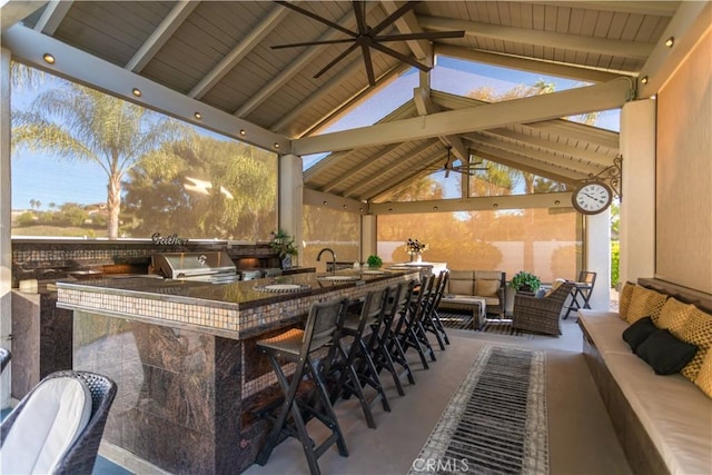 view of patio / terrace featuring a gazebo, an outdoor kitchen, an outdoor hangout area, a grill, and outdoor wet bar