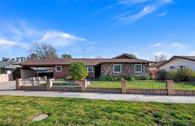 ranch-style home featuring brick siding, a fenced front yard, and a front yard