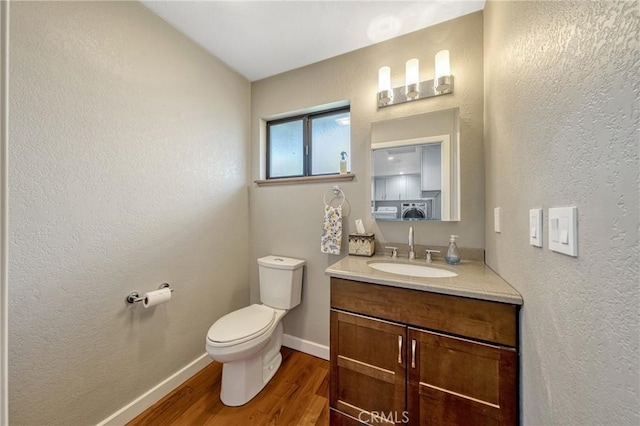 18945 Timber Point Rd, Hidden Valley Lake, CA 95467 - half bathroom with a textured wall, baseboards, toilet, wood finished floors, and vanity