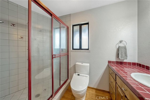 18945 Timber Point Rd, Hidden Valley Lake, CA 95467 - full bath featuring a shower stall, a textured wall, toilet, wood finished floors, and vanity
