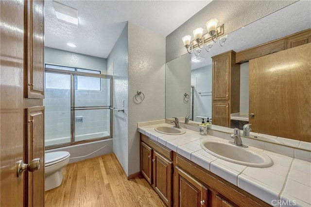 18945 Timber Point Rd, Hidden Valley Lake, CA 95467 - full bathroom featuring a textured ceiling, a sink, double vanity, and wood finished floors