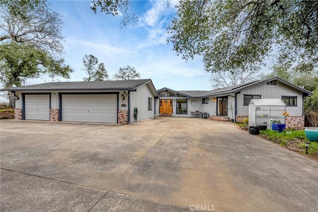 18945 Timber Point Rd, Hidden Valley Lake, CA 95467 - ranch-style house featuring concrete driveway, brick siding, and board and batten siding