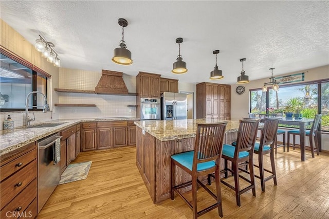 18945 Timber Point Rd, Hidden Valley Lake, CA 95467 - kitchen featuring appliances with stainless steel finishes, a textured ceiling, custom range hood, and a sink