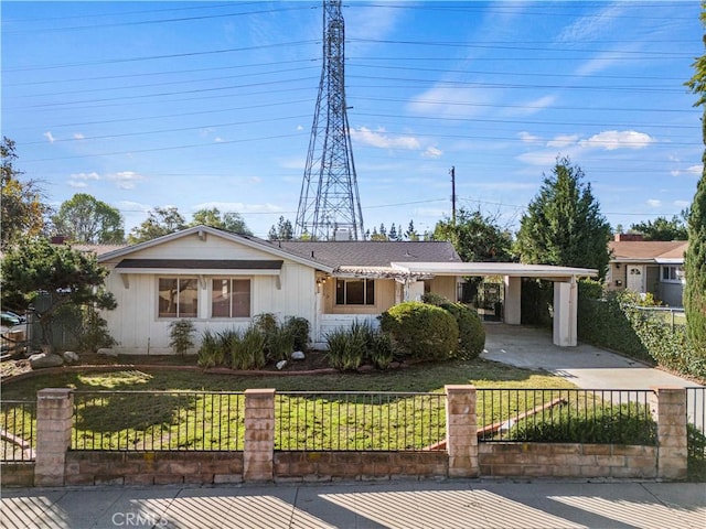 ranch-style house with an attached carport, a fenced front yard, and a front yard