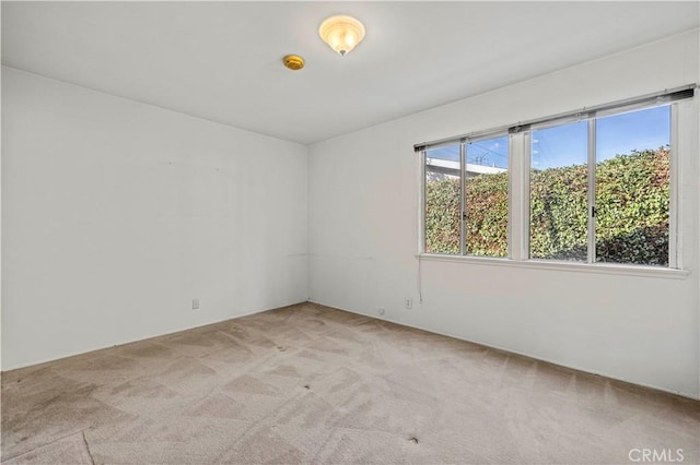 unfurnished room featuring light colored carpet