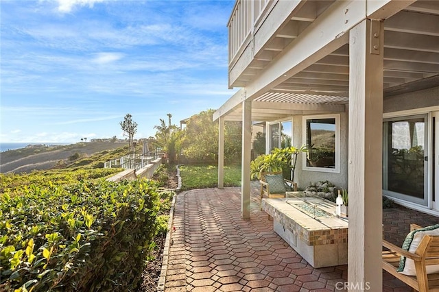 view of patio / terrace with a fire pit and a pergola