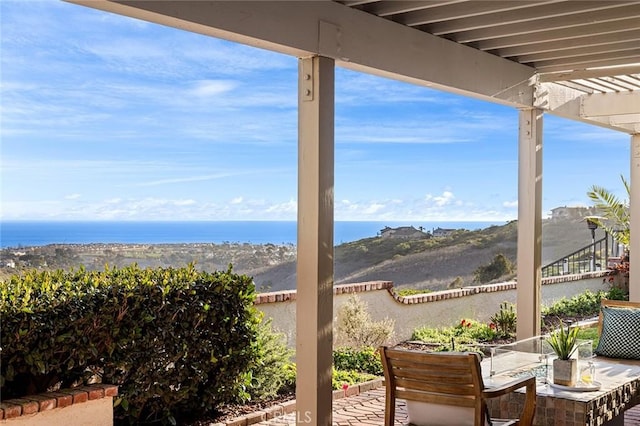 view of patio / terrace with outdoor dining area and a water view