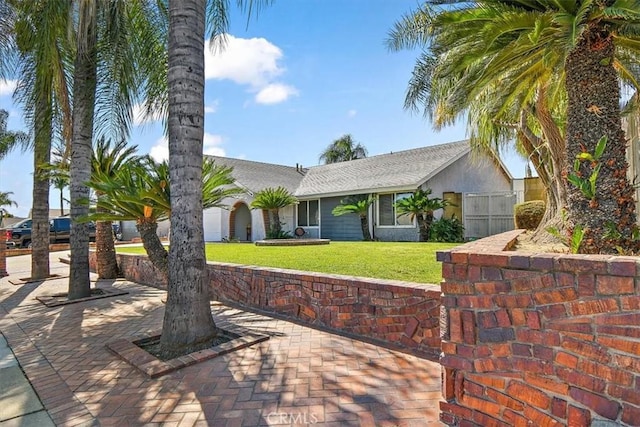 ranch-style house with a front lawn