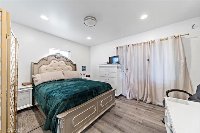 bedroom featuring light wood-type flooring and recessed lighting