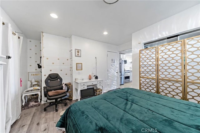 bedroom featuring recessed lighting, freestanding refrigerator, and light wood-style floors