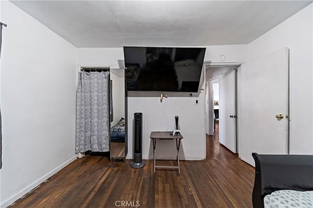 bedroom featuring dark wood-style floors and baseboards