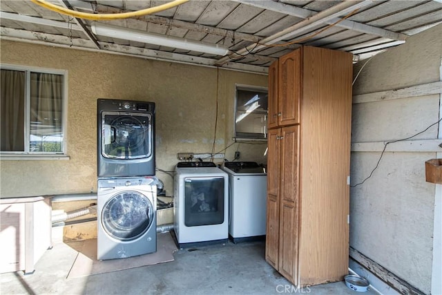 clothes washing area with stacked washer / dryer