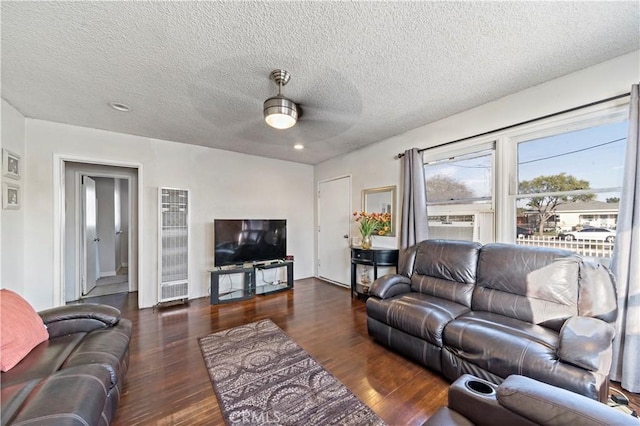 living room with dark wood-style floors and a textured ceiling