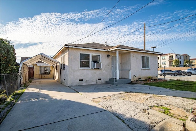 bungalow-style home with cooling unit, fence, driveway, crawl space, and stucco siding