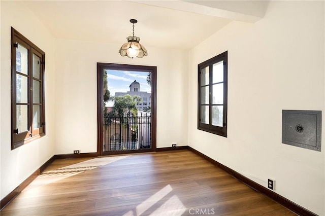 foyer featuring baseboards and wood finished floors