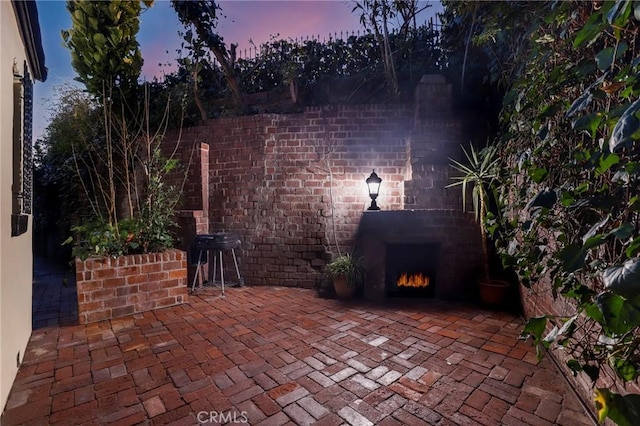 view of patio / terrace featuring an outdoor brick fireplace