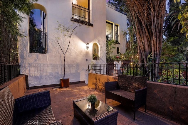 view of patio / terrace featuring a balcony, fence, and outdoor lounge area