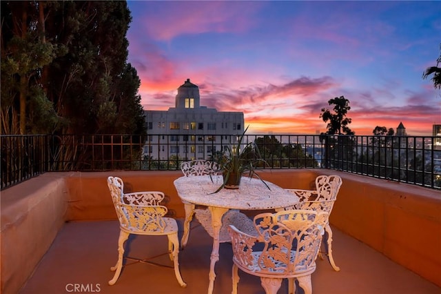 patio terrace at dusk with outdoor dining space