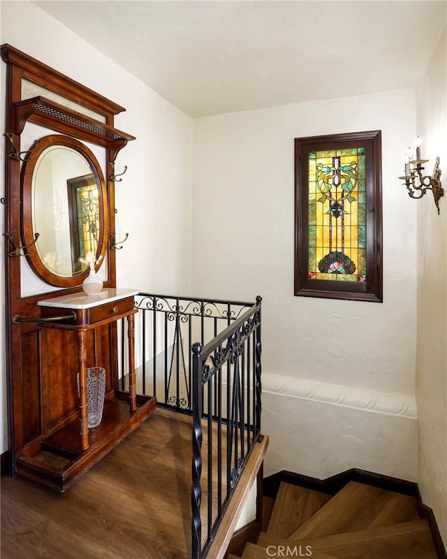 stairway with baseboards and wood finished floors