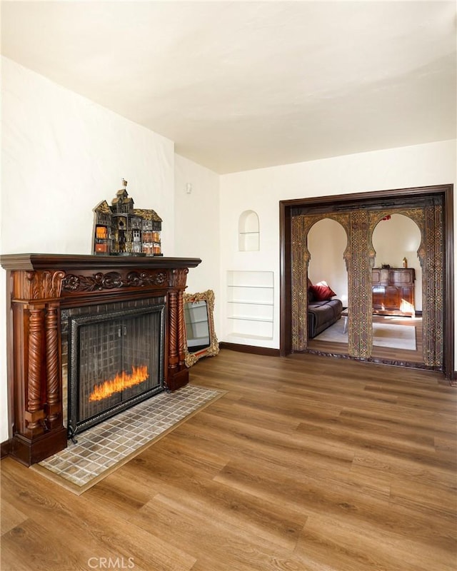 living area featuring a fireplace and wood finished floors
