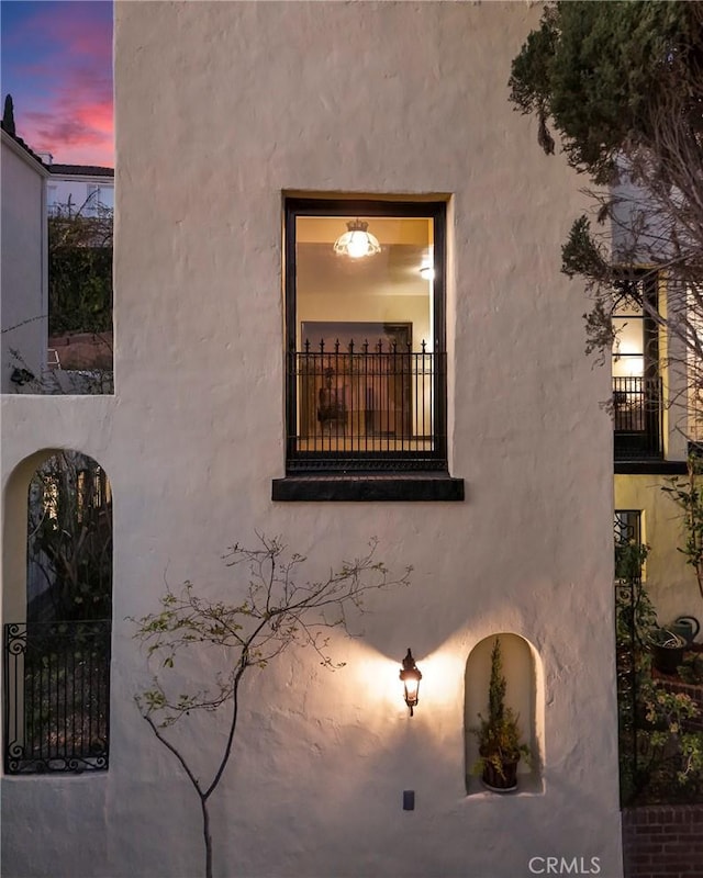 property exterior at dusk with stucco siding