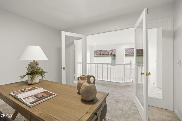 home office featuring french doors and light carpet