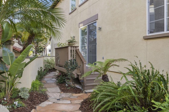 property entrance with stucco siding