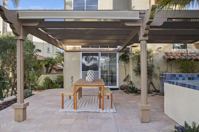 view of patio featuring a pergola and outdoor dining space