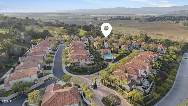 birds eye view of property featuring a mountain view and a residential view