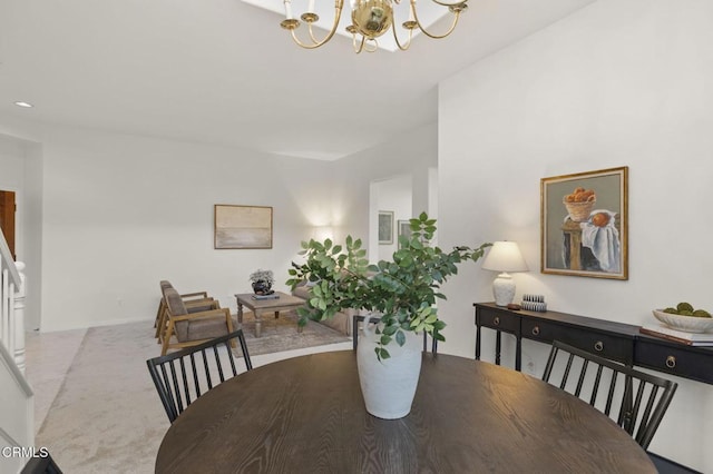 dining space with an inviting chandelier and light colored carpet