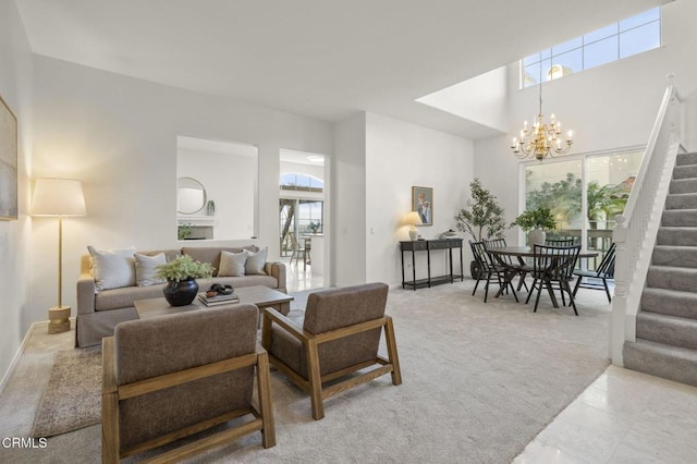 living area featuring light carpet, stairs, and a notable chandelier