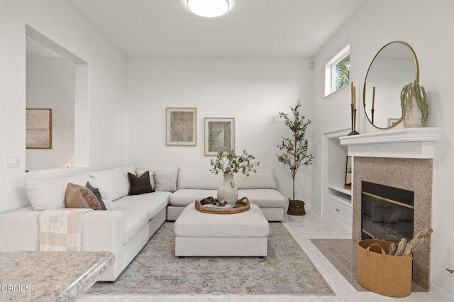 living room with a tiled fireplace