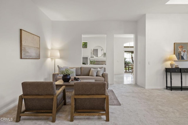 carpeted living area featuring baseboards