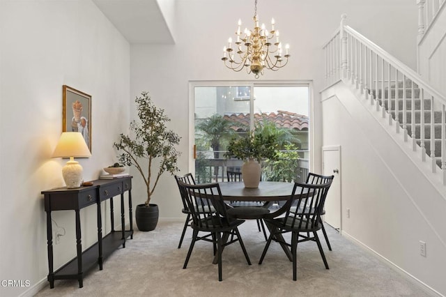 dining area with light carpet, a notable chandelier, stairs, and baseboards