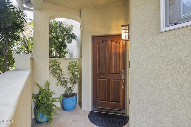 entrance to property featuring stucco siding